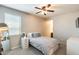 Comfortable bedroom with a bed, bedside table, large mirror and carpeted floor at 11875 W Lone Tree Trl, Peoria, AZ 85383