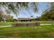 Community building with a well-manicured lawn and stone retaining wall, perfect for gatherings at 11875 W Lone Tree Trl, Peoria, AZ 85383