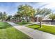 Attractive community clubhouse with manicured lawn, tall shade trees, and sidewalks at 11875 W Lone Tree Trl, Peoria, AZ 85383