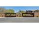Gated community entrance with stone pillars, iron gates, and manicured landscaping at 11875 W Lone Tree Trl, Peoria, AZ 85383