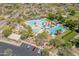 Aerial view of a community pool with waterslides, covered seating, and a parking area at 11875 W Lone Tree Trl, Peoria, AZ 85383