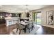 Open concept kitchen and dining area with a stylish chandelier and sliding glass doors leading to the pool at 11875 W Lone Tree Trl, Peoria, AZ 85383