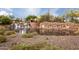 Stunning entrance to Vistancia featuring a waterfall, stone bridge, and lush desert landscaping at 11875 W Lone Tree Trl, Peoria, AZ 85383