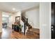 This home's entryway includes beautiful hardwood floors, a staircase, and designer accents at 11875 W Lone Tree Trl, Peoria, AZ 85383