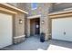 Inviting entryway with stone accents, pavers, and a decorative welcome sign on the front door at 11875 W Lone Tree Trl, Peoria, AZ 85383