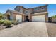 Inviting two-story home with a three-car garage and a beautiful brick paved driveway at 11875 W Lone Tree Trl, Peoria, AZ 85383