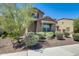 Charming two-story home with desert landscaping, including a tree to the left, and a two-car garage at 11875 W Lone Tree Trl, Peoria, AZ 85383