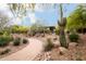 Beautiful desert landscaping and paver walkway leading to a modern home, showcasing curb appeal at 11875 W Lone Tree Trl, Peoria, AZ 85383