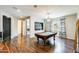 Inviting game room with hardwood floors, a pool table, and designer curtains at 11875 W Lone Tree Trl, Peoria, AZ 85383