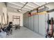 Tidy garage featuring plenty of storage cabinets and fitness equipment at 11875 W Lone Tree Trl, Peoria, AZ 85383