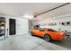 Clean, spacious garage with an orange vintage sports car and ample storage space at 11875 W Lone Tree Trl, Peoria, AZ 85383