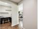 Hallway provides access to an office area with hardwood floors, complemented by views of the open kitchen and dining space at 11875 W Lone Tree Trl, Peoria, AZ 85383