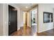 Hallway with dark wood floors, paint in neutral color, and doors leading to rooms at 11875 W Lone Tree Trl, Peoria, AZ 85383