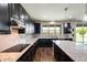 Gourmet kitchen with dark cabinets, granite countertops, and stainless steel appliances at 11875 W Lone Tree Trl, Peoria, AZ 85383