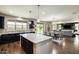 Open-concept kitchen featuring granite countertops, island, and eat-in area at 11875 W Lone Tree Trl, Peoria, AZ 85383