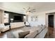 Inviting living room featuring hardwood floors, comfortable seating, designer touches, and an abundance of natural light at 11875 W Lone Tree Trl, Peoria, AZ 85383