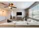 Upstairs living area featuring a ceiling fan, television, white couch, and carpet at 11875 W Lone Tree Trl, Peoria, AZ 85383