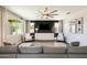 Bright living room with neutral colors, large windows, stylish ceiling fan, and comfortable seating arrangement at 11875 W Lone Tree Trl, Peoria, AZ 85383