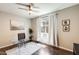 Bright home office with glass desk, ceiling fan, neutral walls, and hardwood floors at 11875 W Lone Tree Trl, Peoria, AZ 85383