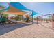 A sandy playground provides with an engaging play area featuring slides, swings and climbing structures at 11875 W Lone Tree Trl, Peoria, AZ 85383