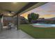 Covered patio with outdoor seating and view of the sparkling backyard pool at 11875 W Lone Tree Trl, Peoria, AZ 85383
