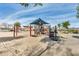 Inviting playground with slides, climbing structures, and shade canopies, perfect for active play at 11875 W Lone Tree Trl, Peoria, AZ 85383
