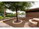 Tranquil pool area with shade umbrellas, lush landscaping, and comfortable seating options at 11875 W Lone Tree Trl, Peoria, AZ 85383