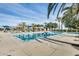 Resort-style community pool with palm trees and plenty of poolside seating at 11875 W Lone Tree Trl, Peoria, AZ 85383