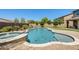 Backyard showcases a sparkling pool with spa and lush landscaping, offering a tranquil outdoor escape at 11875 W Lone Tree Trl, Peoria, AZ 85383