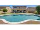 Backyard featuring a large private swimming pool with Baja shelf and patio seating areas at 11875 W Lone Tree Trl, Peoria, AZ 85383