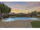 Lovely pool and spa combination surrounded by desert landscaping, creating a serene and private outdoor retreat at 11875 W Lone Tree Trl, Peoria, AZ 85383