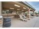 Covered poolside cabana with lounge seating and tables for relaxing at 11875 W Lone Tree Trl, Peoria, AZ 85383