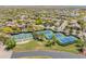 Aerial view of tennis courts surrounded by lush landscaping in a well-maintained community at 11875 W Lone Tree Trl, Peoria, AZ 85383
