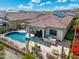 Aerial view of the home showcasing pool, built in BBQ, putting green, and mature landscaping at 12027 S 183Rd Dr, Goodyear, AZ 85338