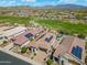 Aerial view of a home with a pool and solar panels in a golf course community at 12027 S 183Rd Dr, Goodyear, AZ 85338