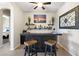Entertaining bar area with wood counter, stools, display shelves, and ambient lighting at 12027 S 183Rd Dr, Goodyear, AZ 85338