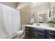 Bathroom featuring a vanity with a large mirror and shower with a white curtain at 12027 S 183Rd Dr, Goodyear, AZ 85338