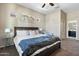 Bedroom featuring a wooden bed frame, soft carpeting, and natural light from two windows at 12027 S 183Rd Dr, Goodyear, AZ 85338