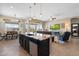 Open concept floor plan with kitchen island overlooking living area at 12027 S 183Rd Dr, Goodyear, AZ 85338