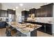 Kitchen featuring a large island with bar seating and modern stainless steel appliances at 12027 S 183Rd Dr, Goodyear, AZ 85338