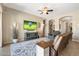 Comfortable living room featuring a ceiling fan and large TV at 12027 S 183Rd Dr, Goodyear, AZ 85338