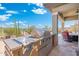 Outdoor kitchen features stainless steel grill and side burner, perfect for backyard cookouts at 12027 S 183Rd Dr, Goodyear, AZ 85338
