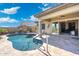 Inviting pool area with covered patio and lush landscaping, perfect for outdoor relaxation at 12027 S 183Rd Dr, Goodyear, AZ 85338