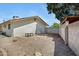 Large backyard with landscaping, gravel, a block fence, and a shaded area at 1215 E Geneva Dr, Tempe, AZ 85282