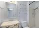 Bright bathroom featuring white vanity, glass shelves, and a tiled shower at 1215 E Geneva Dr, Tempe, AZ 85282