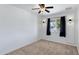 Bright bedroom featuring neutral carpet, ceiling fan, and natural light from the window at 1215 E Geneva Dr, Tempe, AZ 85282
