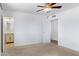 Spacious bedroom with neutral carpet, ceiling fan, and easy access to ensuite bathroom at 1215 E Geneva Dr, Tempe, AZ 85282