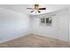 Light-filled bedroom with plush carpeting, ceiling fan, and view of the outdoors at 1215 E Geneva Dr, Tempe, AZ 85282