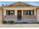 Welcoming front entrance with a decorative wreath, neutral brick accents, and a sheltered porch area at 1215 E Geneva Dr, Tempe, AZ 85282