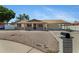Inviting single-story home boasts desert landscaping and a covered carport for convenience and sun protection at 1215 E Geneva Dr, Tempe, AZ 85282